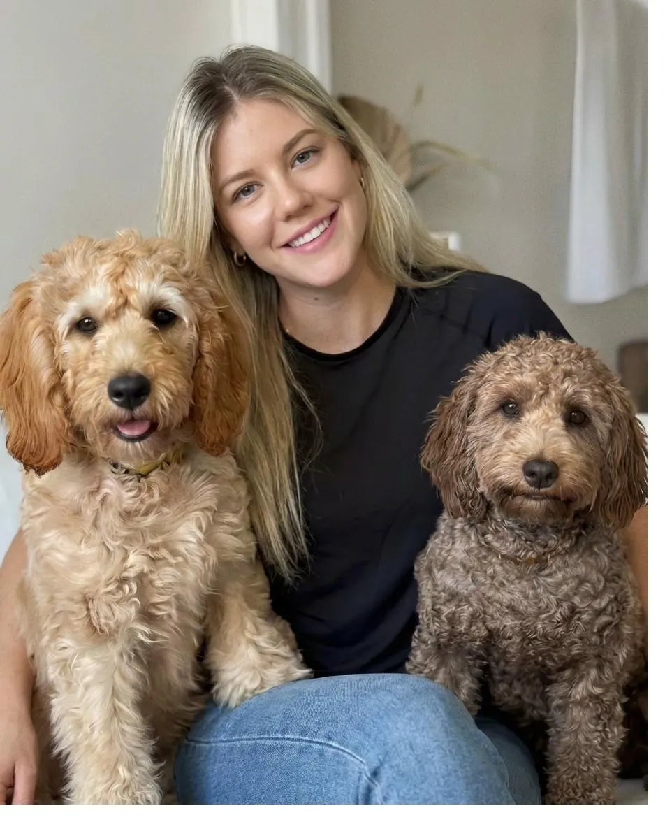 Sitter relaxing at home with dogs