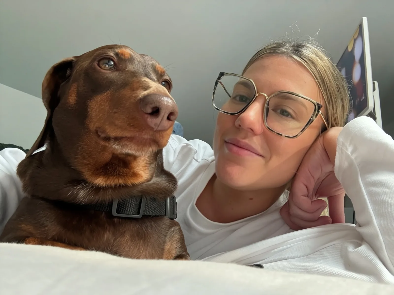 Ash relaxing with her chocolate dachshund